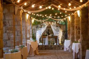 a set up for a wedding with lights and tables at Azienda Agrituristica Bergi in Castelbuono