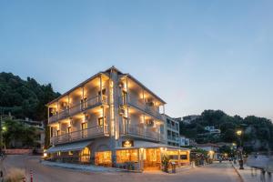 a large building with lights on the side of it at Kelly Beach Hotel in Agios Ioannis Pelio