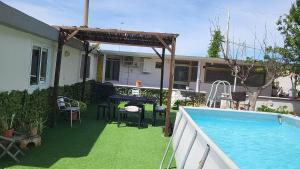 a patio with a table and a swimming pool at Villa Rhaele in Taranto