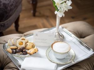 a tray with a plate of cookies and a cup of coffee at The St. Regis Chengdu in Chengdu