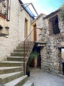 a stone building with stairs leading to a door at The Hideaway - Kastel Novi in Kaštela
