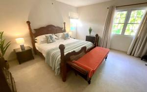 a bedroom with a bed and a chair and a window at Jacks Place 3bd by ZenBreak in Saint Peter +20 photos