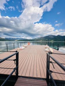 a wooden dock on a body of water at Casa Dani in Colibiţa