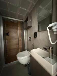 a bathroom with a toilet and a sink and a shower at D'Premium Hotel in Edirne +28 photos