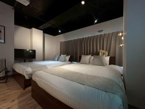 Una cama o camas en una habitación de Neighbor's Hotel 西広島駅前