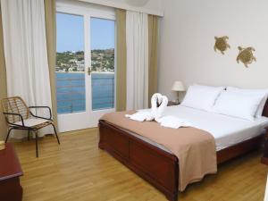 a bedroom with a bed with swans on it at Isalos Stay Andros in Batsi