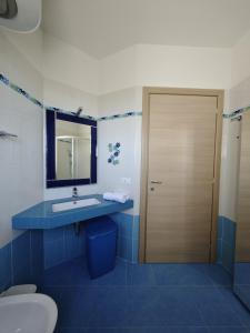 a bathroom with a toilet and a sink and a mirror at iBeach Crispi in Campomarino