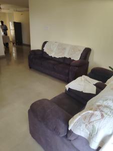 a living room with two couches and a couch at Royal Service Apartment in Rājahmundry