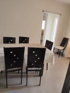 a dining room with a table and chairs at Royal Service Apartment in Rājahmundry