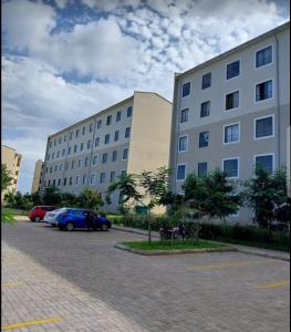 two large buildings with cars parked in a parking lot at 1255 Palm Ridge Estate in Vipingo