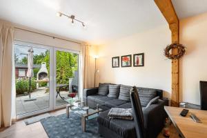 a living room with a couch and a table at Bungalow 73 in Zadelsdorf