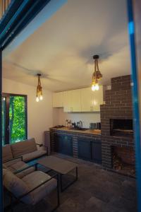 a living room with a couch and a fireplace at SteLar Lake View 2025 in Teşila
