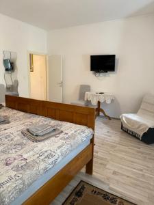 a small room with a bed and a mirror at House Mirjana in Selce