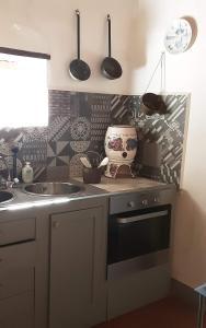 a kitchen with a sink and a counter with utensils at Celle di Lecchi Vigneto in San Sano