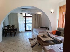 a living room with an archway and a couch and a table at Apartment Sandra in Umag