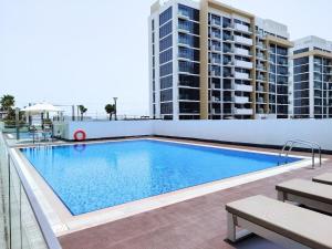 a swimming pool on the roof of a building at Pet Free Studio Apartment Close Downtown Fast Wi-fi in Dubai