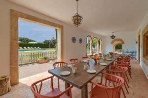 a large dining room with a long table and chairs at Riu Rau in Jávea