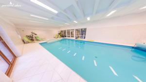 a large indoor swimming pool in a building at Pension Lukas in Karlovy Vary