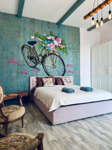 a bedroom with a bed with a bicycle on the wall at Sunset Lovers Residence in Liepāja