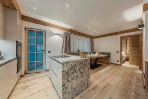 a kitchen with a counter top and a table at Chalet Socrepes - Dolomiti Skyline in Cortina dʼAmpezzo