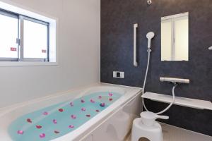 a bathroom with a bath tub with pink hearts on it at おきなわワールドまで車で6分最大9名駐車場2台 hana ohana in Yaese +43 photos