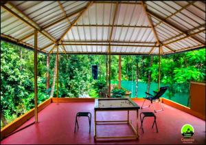 a patio with a ping pong table and two chairs at Casamia Garden in Batheri