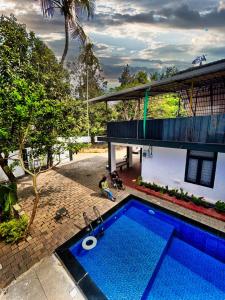 an overhead view of a swimming pool in front of a house at Casamia Garden in Batheri
