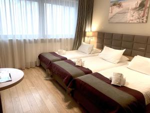 Posteľ alebo postele v izbe v ubytovaní Hotel CONRAD Comfort