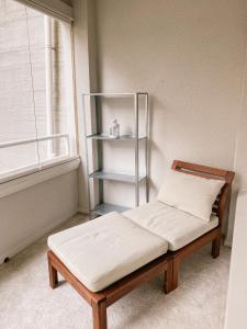 a bed sitting in a room next to a window at Beautiful home close to the sea and city center in Helsinki +2 photos