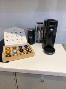 a coffeemaker sitting next to a box of eggs on a counter at Le Petit Glen Uplyme brand new accommodation in Uplyme