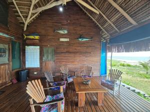 a dining room with chairs and a table in a house at Linga Bay Retreat in Morrumbene