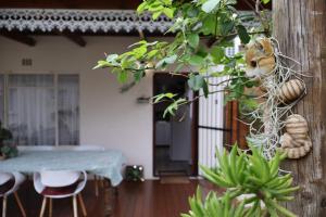 a room with a table and chairs and a tree at Aalkie's Dream in Swellendam