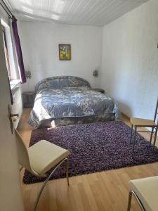 a bedroom with a bed and a rug at Ferienhaus Gisela in Fürstenberg-Havel