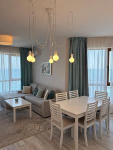 a living room with a table and a couch at On the sand near the sea in Varna City