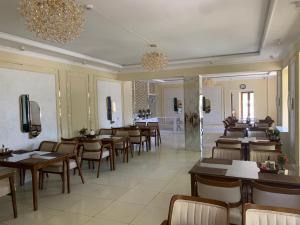 a restaurant with tables and chairs in a room at Hotel crystal palace in Urganch