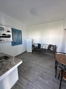 a living room with a refrigerator and a table at #7 Lipsi Port Apartment Sea Views-Ground floor-No#7 in Lipsoi +1 photo