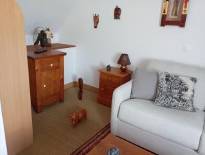 a living room with a couch and a wooden table at La Cousinière in Clohars-Carnoët +1 photo