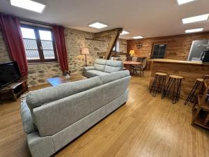 a living room with a couch and a table at La murette in Solignac