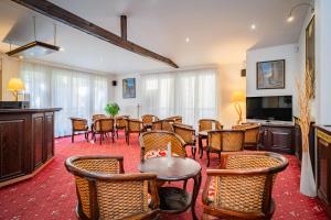 a dining room with a table and chairs at Hotel Atos in Prague