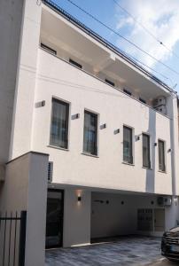 a white building with a garage at SARAJEVO SUITES No 23 Free parking in Sarajevo