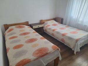 two beds in a small room withermottermottermott at Apartmani Raft in Foča +2 photos