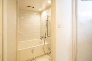 a bathroom with a shower and a tub at 難波民泊301 in Osaka +16 photos
