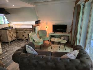 a living room with a couch and a table at Tipi d'Amis in Durbuy