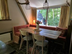 a wooden table and chairs in a room with a window at Tipi d'Amis in Durbuy