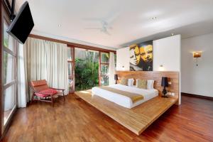 1 dormitorio con 1 cama grande y TV. en Villa Amira Legian, en Legian 42 fotos más