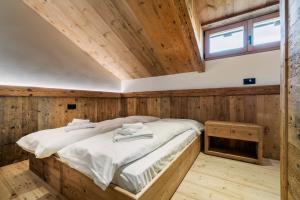 Ένα ή περισσότερα κρεβάτια σε δωμάτιο στο Chalet Ronco - Dolomiti Skyline