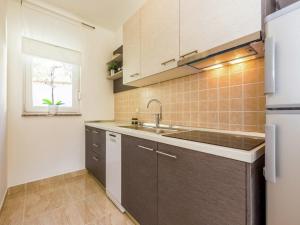 a small kitchen with a sink and a window at Contemporary Holiday Home in Dramalj with Swimming Pool in Dramalj