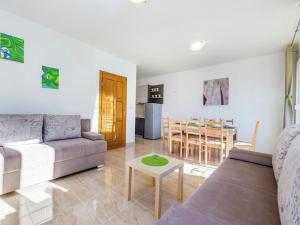 a living room with a couch and a table at Contemporary Holiday Home in Dramalj with Swimming Pool in Dramalj