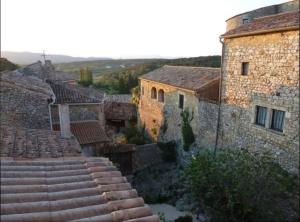 a group of stone buildings and steps in a village at Chambre d hôtes labastide de virac in Labastide-de-Virac