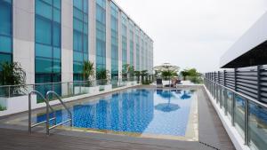 a swimming pool on the side of a building at Grand Anara Airport Hotel in Tangerang